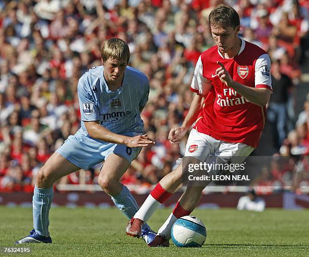Michael Johnson of Manchester City attempts to tackle Alexander Hleb of Arsenal during the Premiership football match against Arsenal at the Emirates...