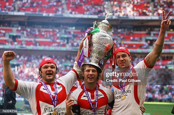 Keiron Cunningham, Sean Long and Jason Cayless celebrate with the trophy during the Carnegie Challenge Cup Final between St.Helens and Catalans...