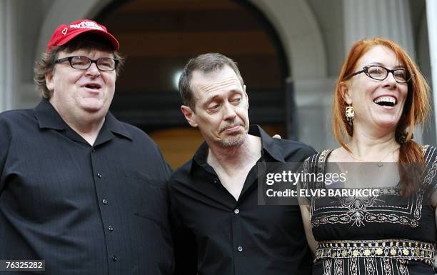 Movie director Michael Moore accompanied by actor director Steve Buschemi, and Jo Anderson stand in the red carpet area at the 13th Sarajevo Film...