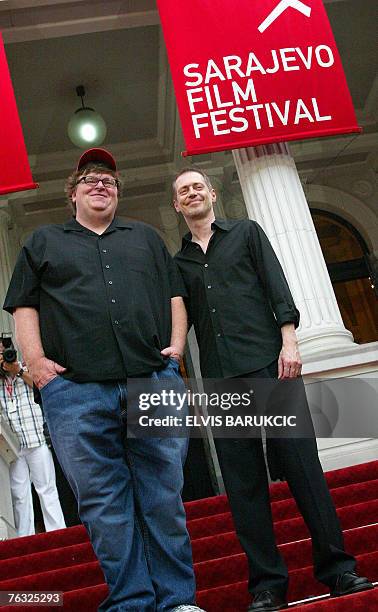 Movie director Michael Moore accompanied by actor director Steve Buschemi, stand in the red carpet area at the 13th Sarajevo Film Festival on it's...