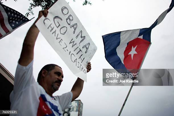 Rinaldo Martinez holds a sign reading Obama Go with Chavez and Castro as he protest against the Democratic presidential candidate, U.S. Sen. Barack...