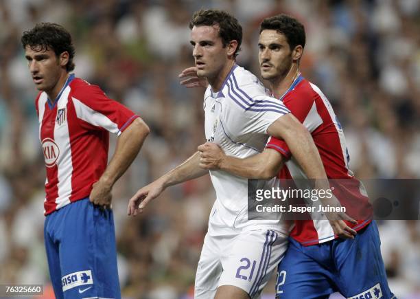 Christoph Metzelder of Real Madrid scuffles with Pablo Ibanez of Atletico de Madrid during the Spanish League match between Real Madrid and Atletico...