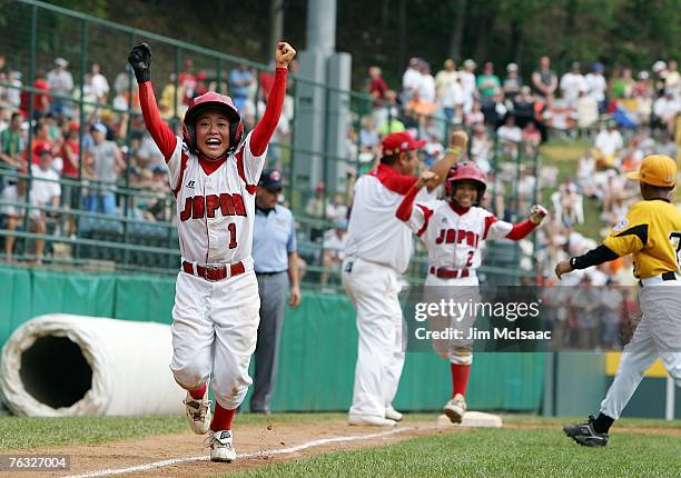 Hiroki Takewaki and Kanta Hiraide of the Japanese team from Tokyo, Japan celebrate as the run the bases after teammate Ryo Kanekubo's , walk off...