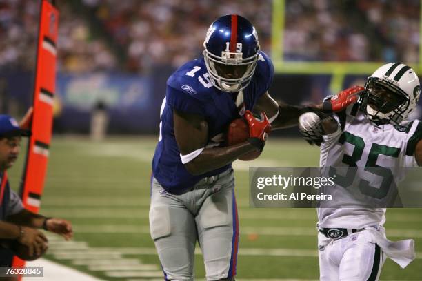 New York Giants wide receiver Anthony Mix battles New York Jets cornerback Manny Collins after a sideline catch during a preseason game at Giants...