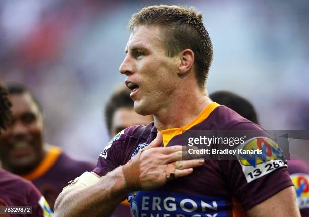 Brad Thorn of the Broncos gestures to the crowd as he puts his hand on his heart after scoring a try during the round 24 NRL match between the...