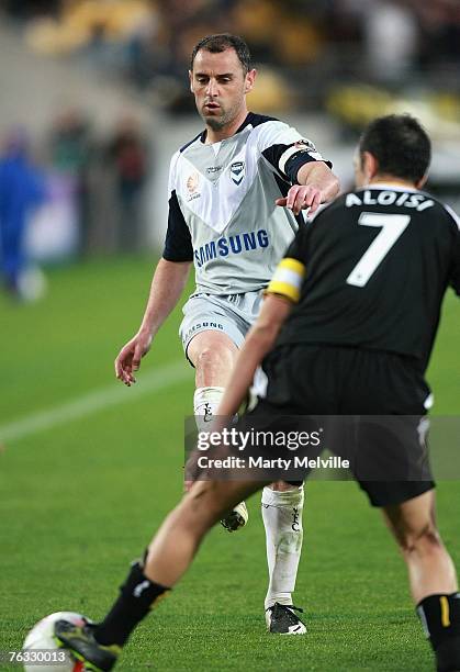 Kevin Muscat of the Victory is blocked by Ross Aloisi of the Phoenix during the round one Hyundai A-League match between Wellington Phoenix and...