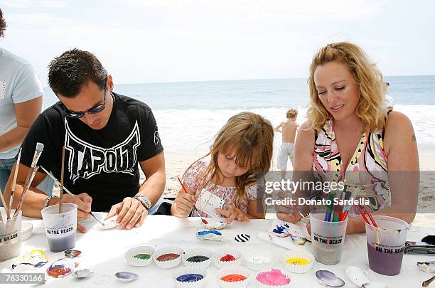 Actor Antonio Sabato with daughter Mina Sabato and Actress Virginia Madsen paint shells on the beach at the French Connection's "Kids connection to...