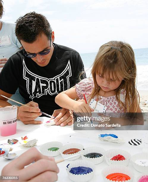 Actor Antonio Sabato with daughter Mina Sabato paint shells on the beach at the French Connection's "Kids connection to benefit The Art Of Elysium"...