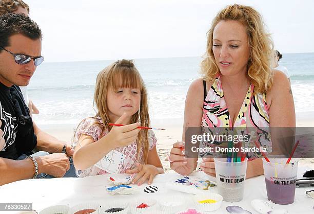 Actor Antonio Sabato with daughter Mina Sabato and Actress Virginia Madsen paint shells on the beach at the French Connection's "Kids connection to...