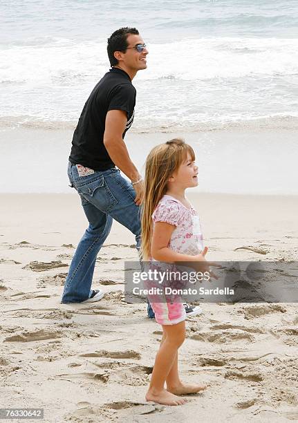 Actor Antonio Sabato with daughter Mina Sabato play on the beach at the French Connection's "Kids connection to benefit The Art Of Elysium" on August...