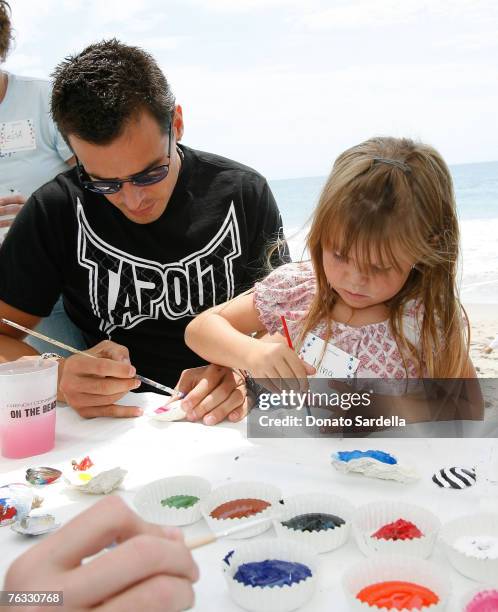 Actor Antonio Sabato with daughter Mina Sabato paint shells on the beach at the French Connection's "Kids connection to benefit The Art Of Elysium"...