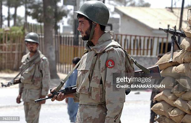 Pakistani paramilitary soldier stands guard alongside a bunker during a strike in Quetta, 26 August 2007, on the first death anniversary of...