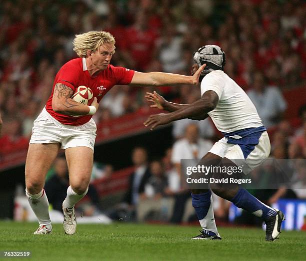 Alix Popham of Wales holds off Serge Betsen during the Rugby Union International match between Wales and France at the Millennium Stadium on August...