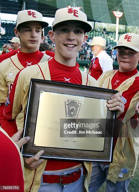 Hunter Jackson of the Southeast team from Warner Robins, Georgia poses with the championship plaque after defeating the Japanese team from Tokyo,...