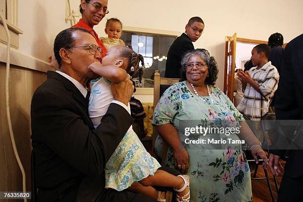 Hazzert Gillett and wife Rita gather with family members after services in the Greater Little Zion Missionary Baptist Church in the Lower Ninth Ward...