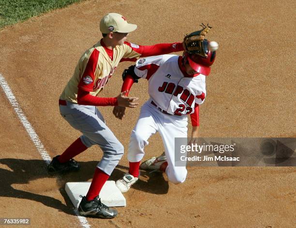 Yuri Yasuda of the Japanese team from Tokyo, Japan is safe at third with an RBI triple ahead of the throw to Hunter Jackson of the Southeast team...