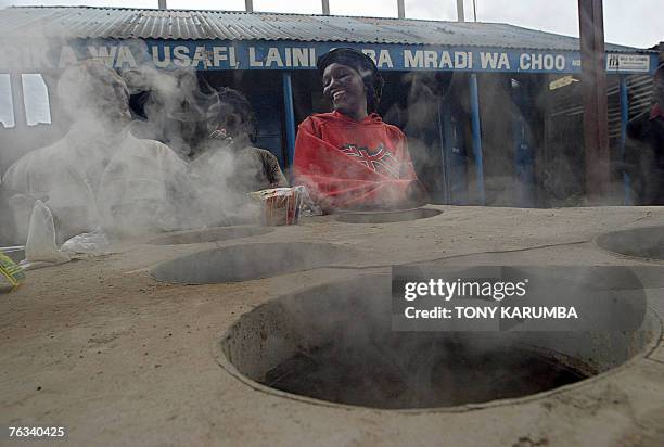 By LUCIE PEYTERMANN - FILES - Picture made 11 August 2007 shows slum residents cooking on an improvised garbage incinerator at Africa's second...