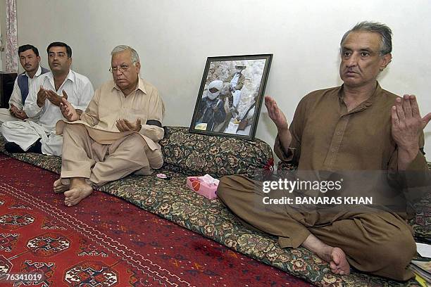 Son of slain rebel tribal chief Nawab Akbar Bugti, Talal Bugti and others pray during a special prayer on the first death anniversary of Bugti in...