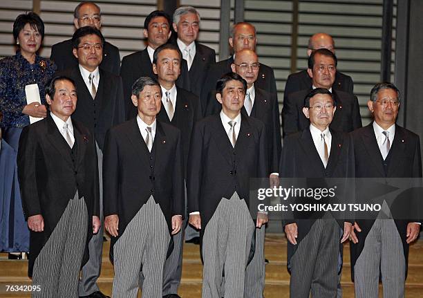 Japanese Prime Minister Shinzo Abe and his newly appointed cabinet members pose for a group photo at the Imperial Palace in Tokyo, 27 August 2007,...