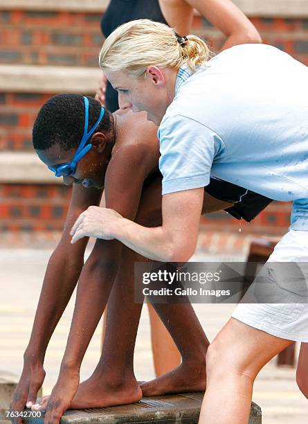 Swimmer Charlene Wittstock coaches children during a training session on December 2, 2006 in Richards Bay, South Africa.