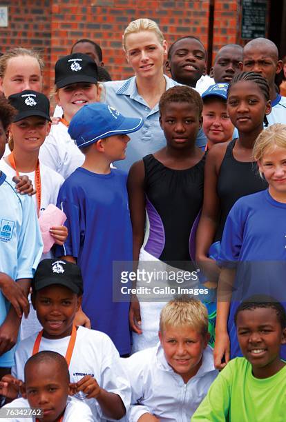 Swimmer Charlene Wittstock poses with participants of a childrens swim training she coached during a training session on December 2, 2006 in Richards...