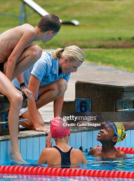 Swimmer Charlene Wittstock coaches children during a training session on December 2, 2006 in Richards Bay, South Africa.