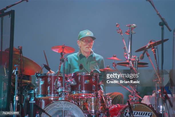 English musician and drummer Ginger Baker performs live on stage at the drum kit at Virgin Records 21st Birthday Party concert in London in June...