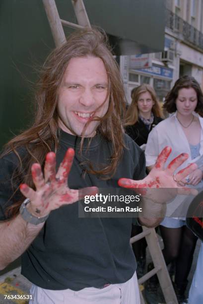 English musician and singer Bruce Dickinson of heavy metal band Iron Maiden pictured with red paint on his hands at the unveiling of a promotional...