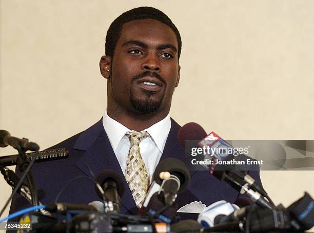 Atlanta Falcons quarterback Michael Vick makes a statement to reporters at the Omni Richmond Hotel after agreeing to a guilty plea on charges...