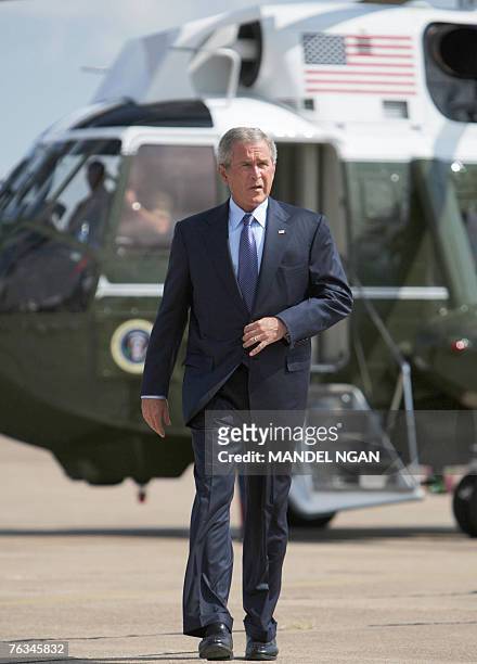 President George W. Bush makes his way to the lectern to comment on the resignation of Attorney General Alberto Gonzales 27 August 2007 on the tarmac...
