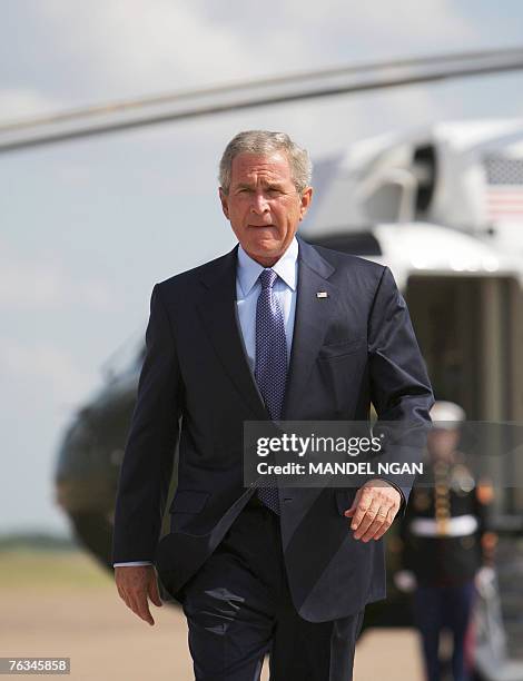 President George W. Bush makes his way to the lectern to comment on the resignation of Attorney General Alberto Gonzales 27 August 2007 on the tarmac...