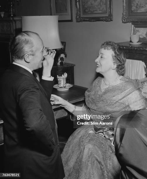 English photographer Cecil Beaton and Millicent Hearst, widow of media mogul William Randolph Hearst, at Gilbert and Kitty Miller's New Year's Eve...