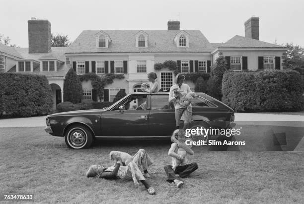 Mrs Roy Chapin and family with an AMC Hornet Sportabout wagon and four labrador puppies outside their Grosse Pointe, Michigan home, circa 1972. A...