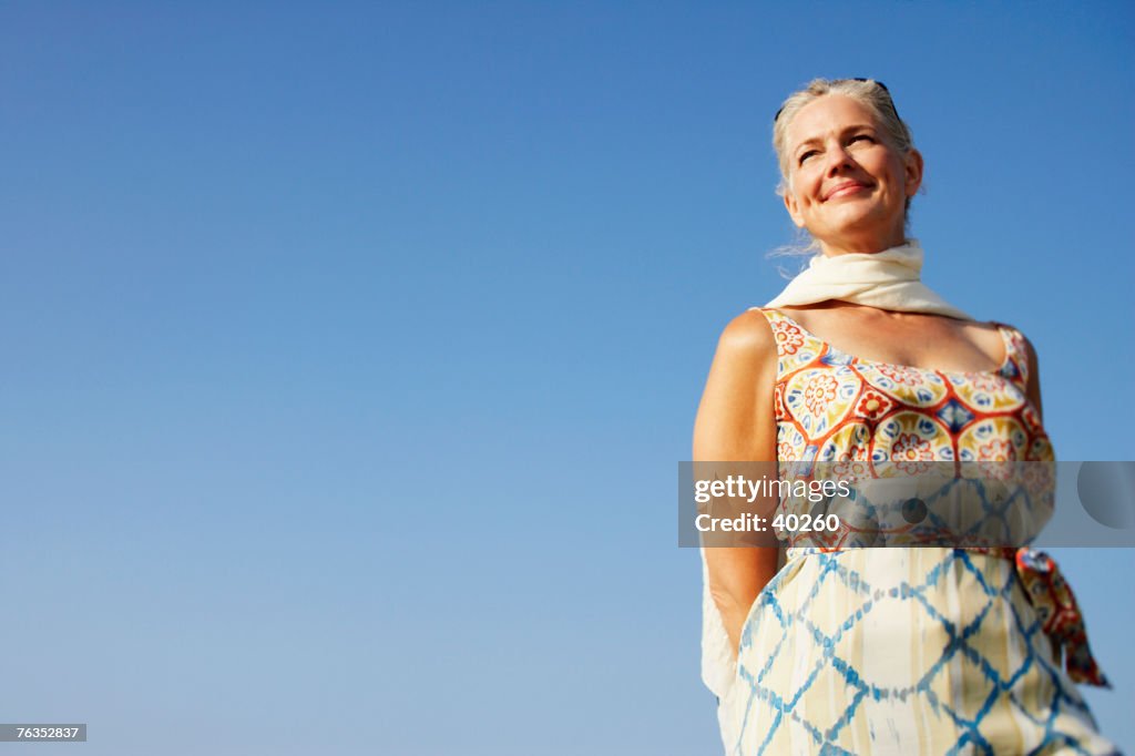 Low angle view of a mature woman looking away and smiling