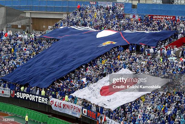 Fans of Japan's national soccer team unfurls a giant shirt and Japanese flag during halftime in a World Cup match against Turkey June 18, 2002 in...