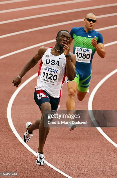 LaShawn Merritt of the United States of America leads from Andres Silva of Uruguay during the Men's 400m Heats on day four of the 11th IAAF World...