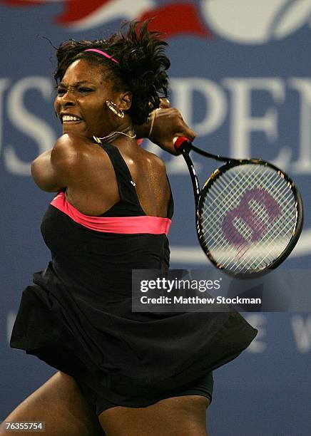 Serena Williams follows through on a return shot against Angelique Kerber of Germany during day one of the U.S. Open at the Billie Jean King National...