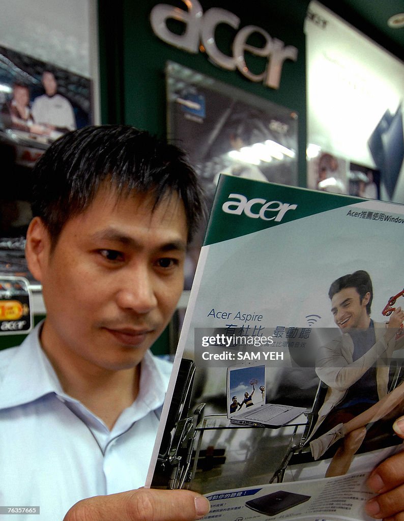 A man reads an Acer advertisement at a l