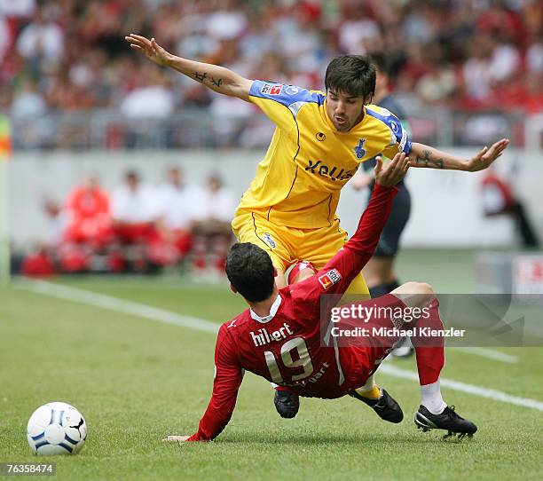 Blagoy Georgiev of Duisburg vies for the ball with Roberto Hilbert of Stuttgart during the Bundesliga match between VfB Stuttgart and MSV Duisburg at...