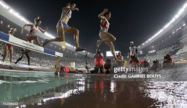 Russia's Yekaterina Volkova and France's Sophie Duarte compete during the women's 3000m steeplechase final, 27 August 2007, at the 11th IAAF World...