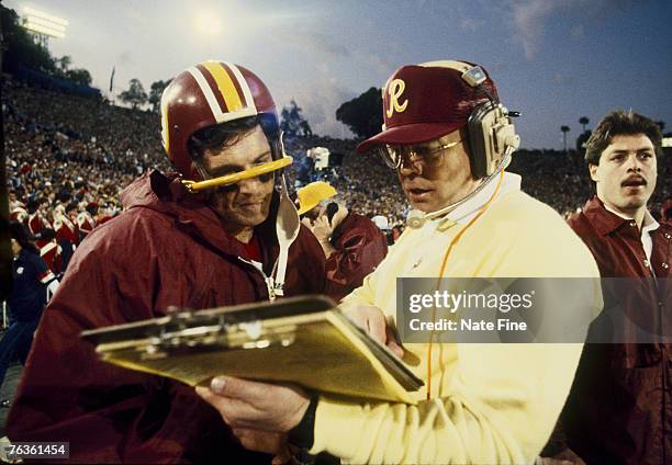 Pro Football Hall of Fame and Washington Redskins head coach Joe Gibbs discussing a play with Wahington quarterback Joe Theismman during the 4th...