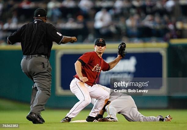 Chris Burke of the Houston Astros applies the tag to Jose Bautista of the Pittsburgh Pirates at second base during the third inning of the MLB game...