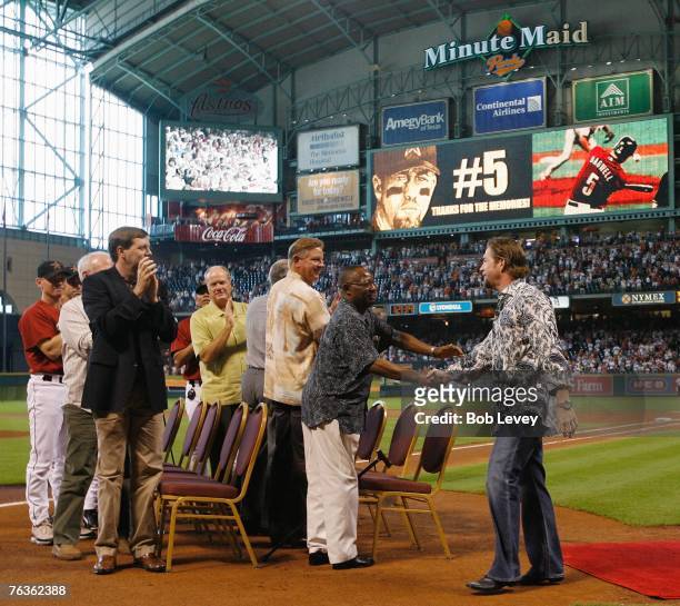 Former first baseman Jeff Bagwell of the Houston Astros is welcomed by former Houston Astros Jimmy Wynn, Larry Dierker, Nolan Ryan, Mike Scott and...