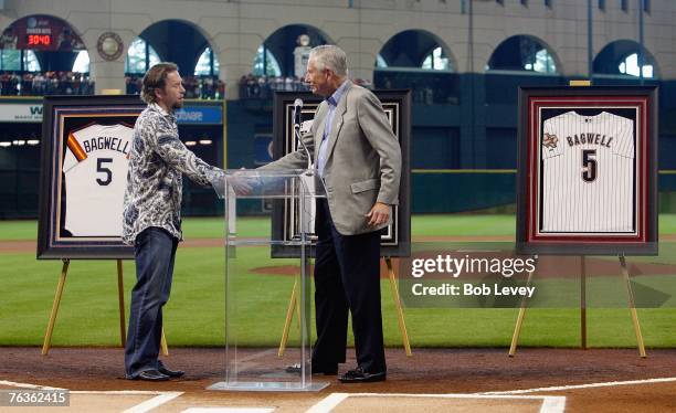 Former first baseman Jeff Bagwell of the Houston Astros is congratulated by Houston Astros owner Drayton McLane, Jr. During a ceremony to retire his...
