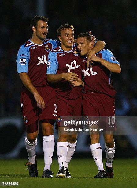 Craig Bellamy of West Ham celebrates with Mark Noble and Lucas Neill of West Ham after he scored the first goal during the Carling Cup match between...