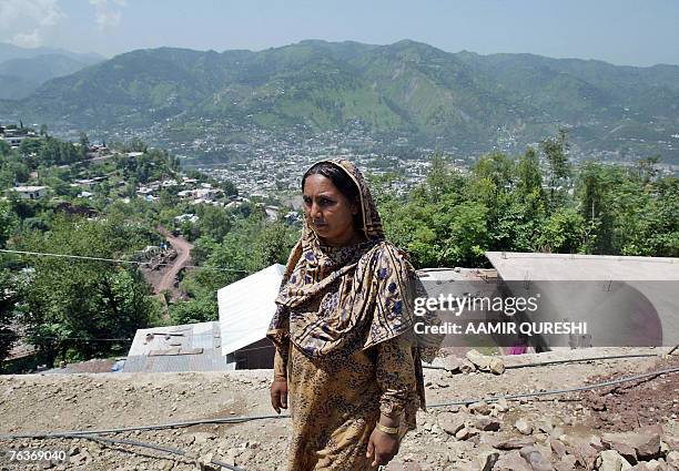 In this picture taken 16 August 2007, Pakistani Kashmiri woman Sajila Begum looks after a five-room school made of sheets of corrugated iron, in a...