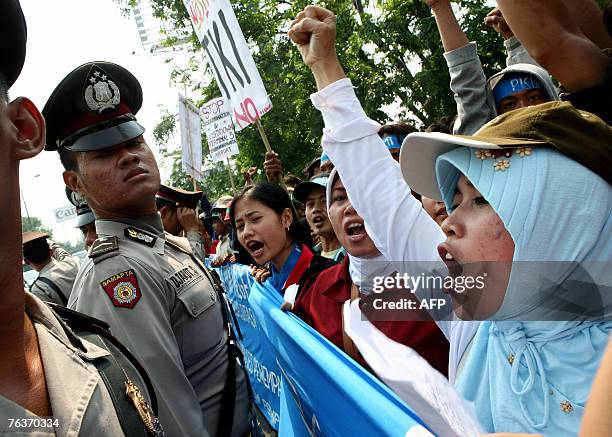 Indonesian migrant workers shout slogans during a demonstration at the Soekarno-Hatta International airport in Jakarta, 29 August 2007. Several...
