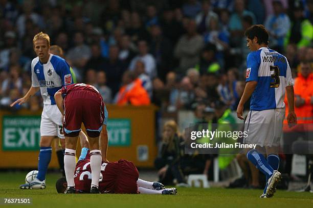 Kieron Dyer of West Ham goes down injured after a tackle from Joe Jacobson of Bristol Rovers during the Carling Cup match between Bristol Rovers and...