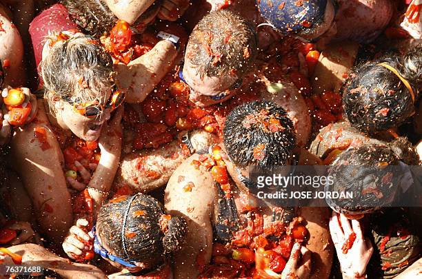 People throw tomatoes during the Tomatina festival that takes place on the last Wednesday of August in Bunol, 29 August 2007. Some 40,000 Spaniards...