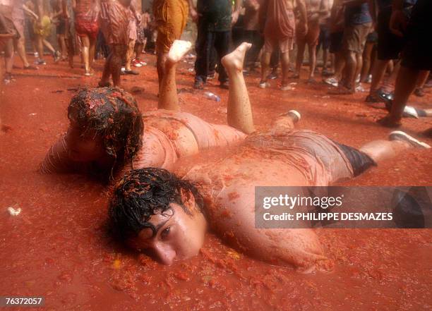 People swim in tomatoes during the Tomatina festival that takes place on the last Wednesday of August in Bunol, 29 August 2007. Some 40,000 Spaniards...